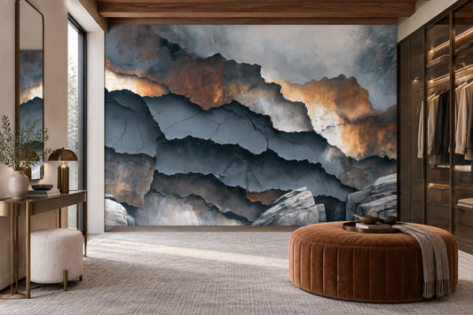 Layered stone abstract wall mural in a dressing room with a gold console, a white boucle stool and a cognac tufted ottoman
