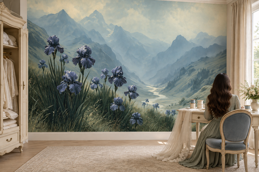 Blue iris meadow mural in a bedroom where a woman sits at a vanity desk with a French chair beside an armoire