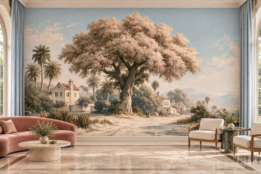 Blush blossom tree and Mediterranean village mural behind a dusty pink sofa, a round table and two cream armchairs on a marble floor