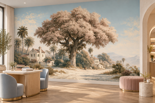Mediterranean village and blossom tree mural in a cafe with a round wood table, blue chairs and a pink pouf beside an arched doorway