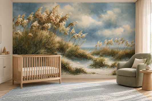 Dune grass and blue sky mural in a nursery with a wooden crib, a sage armchair and a blue rug
