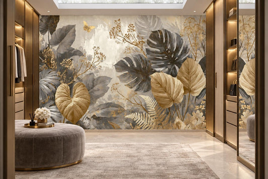 Gray monstera and gold leaf wall mural in a walk-in dressing room with glass-front cabinets and a tufted ottoman