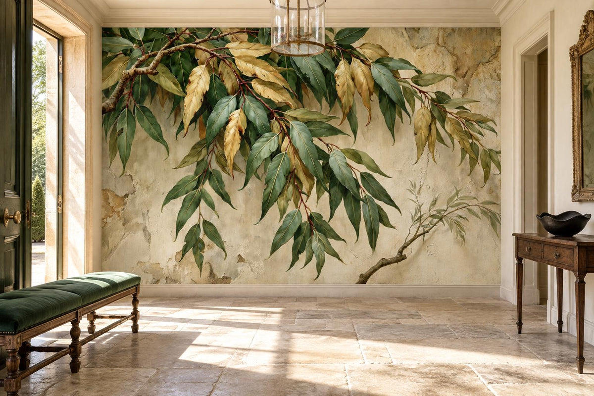 Green and gold leaf branch wall mural on cracked ivory plaster in a sunlit entry hall with a green velvet bench