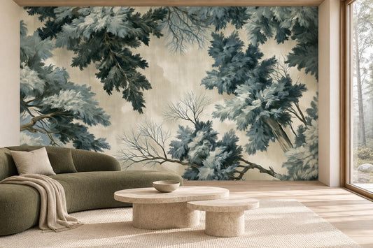 Evergreen forest canopy wall mural in a living room with an olive curved sofa and travertine coffee tables