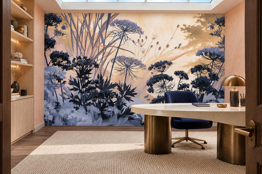 Peach and navy meadow wallpaper mural in a home office with a round white desk on a brass base and built-in shelves